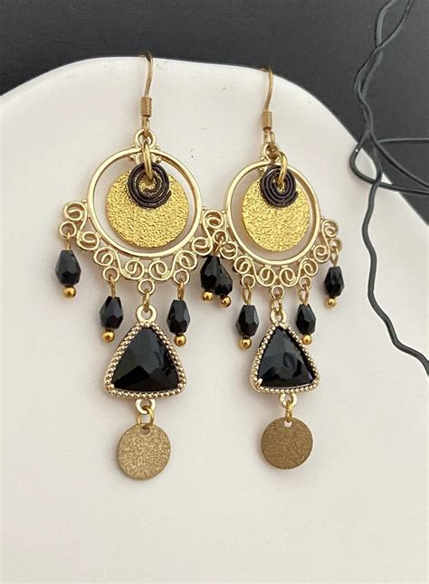 Une sélection de boucles d'oreilles noires Swarovski, incluant des puces, des pendants et des créoles.