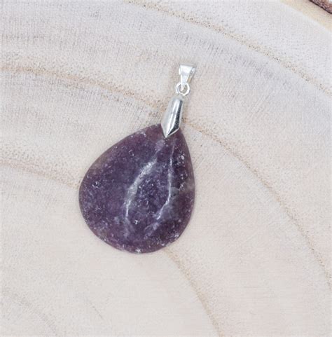 photo d'un pendentif en pierre violette de forme triangulaire