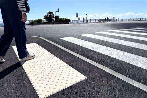 Photographie de bandes podotactiles au bord d'un passage piéton