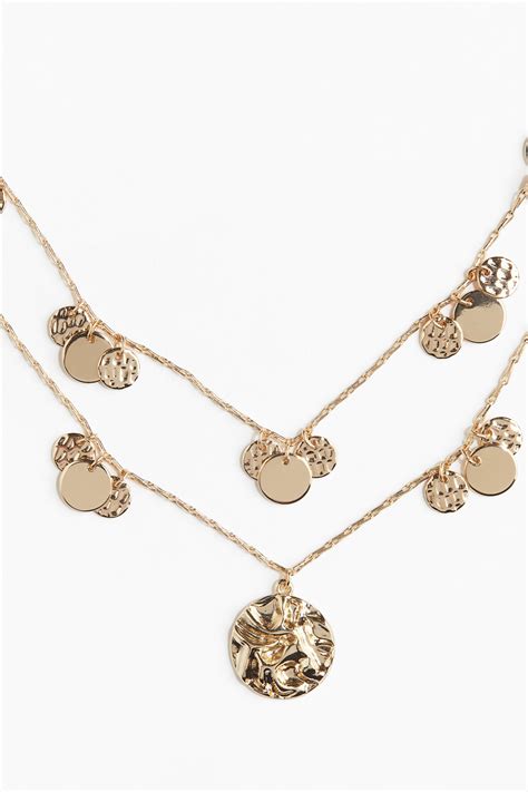 Collier avec deux pendentifs en forme de puzzle qui s'emboîtent