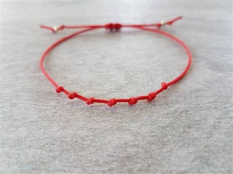 Représentation d'un bracelet fil rouge avec des symboles juifs