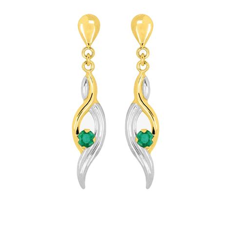 Boucles d'oreilles pendantes en or 18 carats avec une émeraude centrale