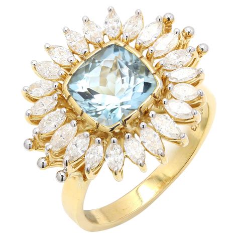 Exemple de bague en or jaune avec une aigue-marine centrale entourée de diamants