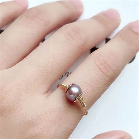 Bague en perle de culture blanche et noire plaqué or