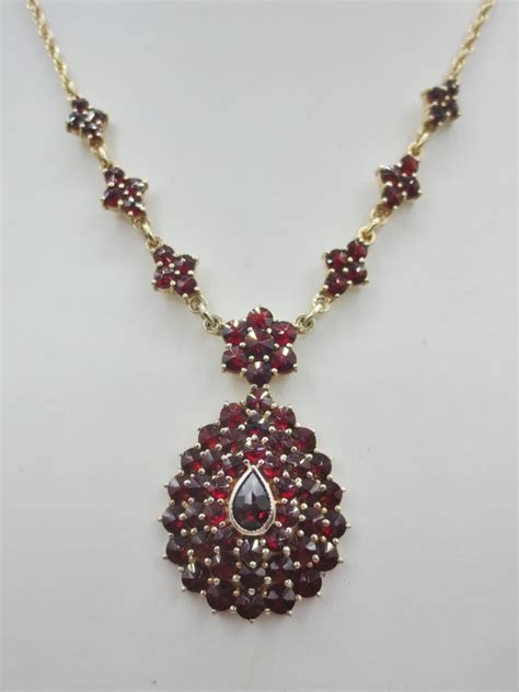 Photographie d'une bague ou d'un collier rivière serti de grenats