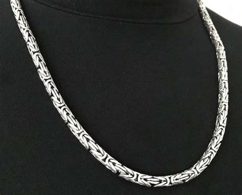 Collection de chaînes en argent pour homme de différentes épaisseurs et longueurs.