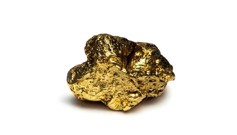 Pépite d'or à côté d'un outil de mineur