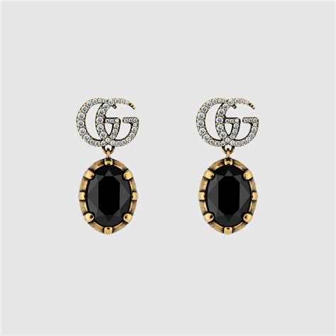 Une sélection de bijoux Gucci, notamment des boucles d'oreilles GG Marmont et une bague Horsebit.