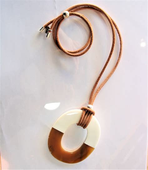 Photo d'un sautoir élégant avec un pendentif en corne de buffle et des perles de grenat