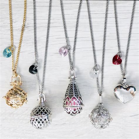 Collection variée de bolas de grossesse aux designs divers : cage, animal, symboles.