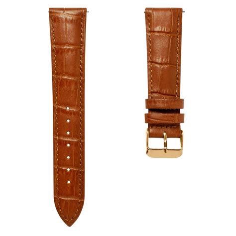 Gros plan sur un bracelet de montre en cuir marron patiné avec une boucle ardillon.